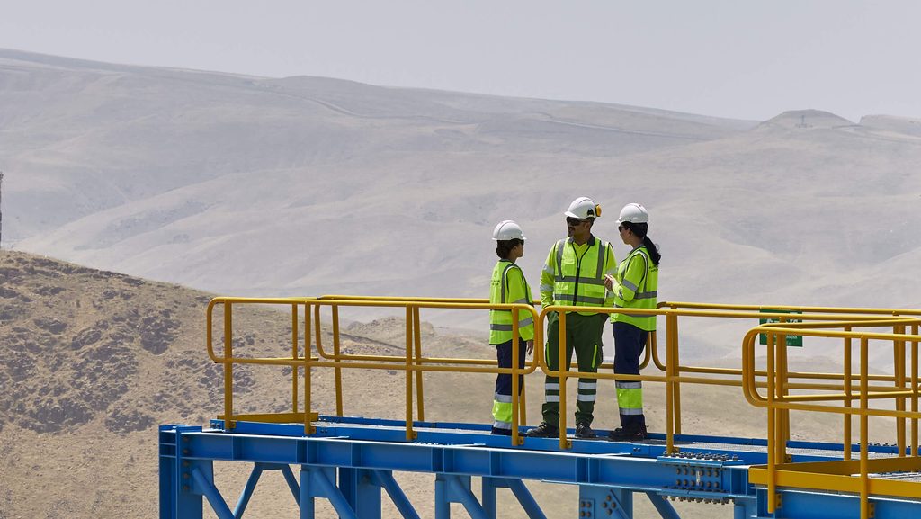 Three People Overlooking Hills Compressed